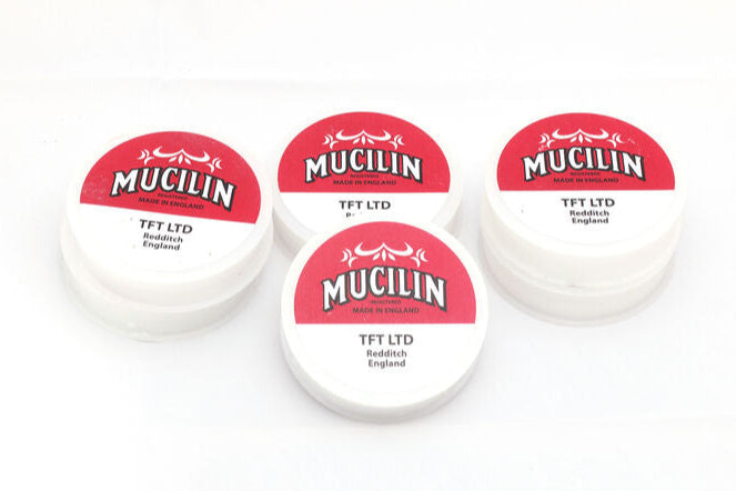 Four containers of Mucilin on a white background