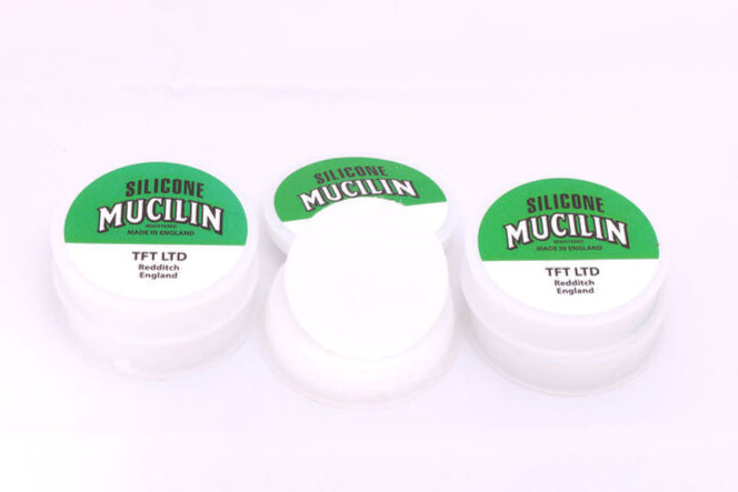 Three containers of silicone Mucilin with green labels on a white background